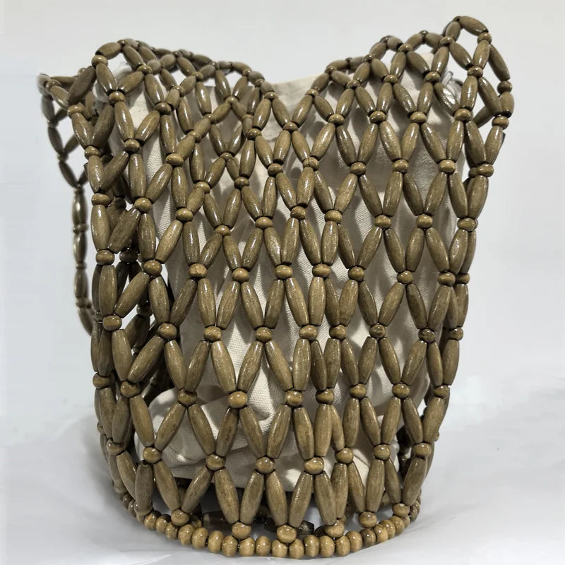 Hollow wood bead straw bag lady fashion brand texture drawstring design shoulder bag simple versatile cylindrical crossbody bag
