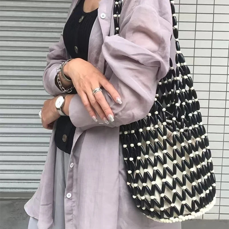 Hollow wood bead straw bag lady fashion brand texture drawstring design shoulder bag simple versatile cylindrical crossbody bag