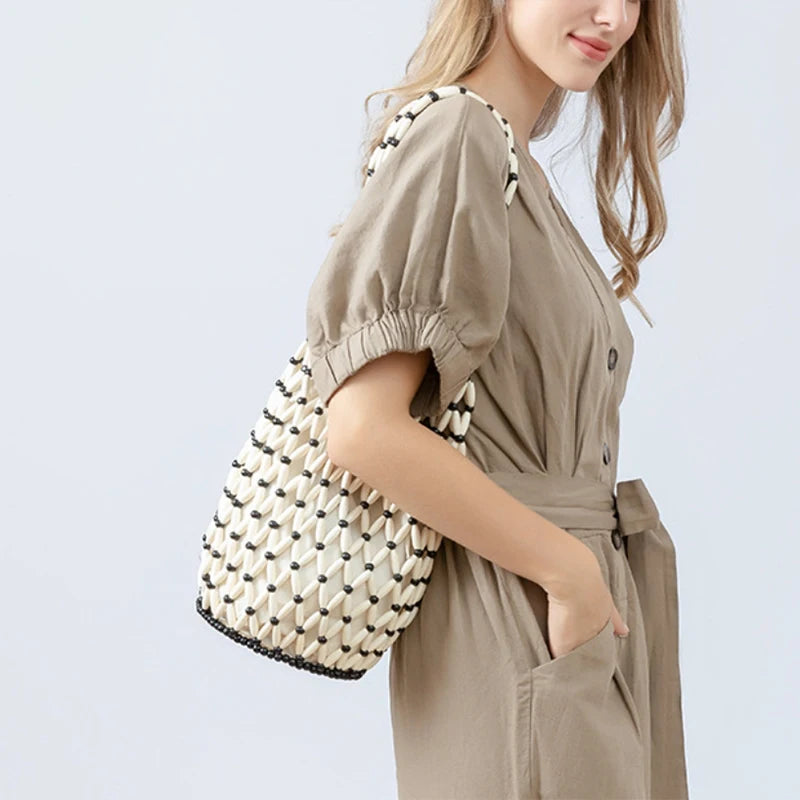 Hollow wood bead straw bag lady fashion brand texture drawstring design shoulder bag simple versatile cylindrical crossbody bag