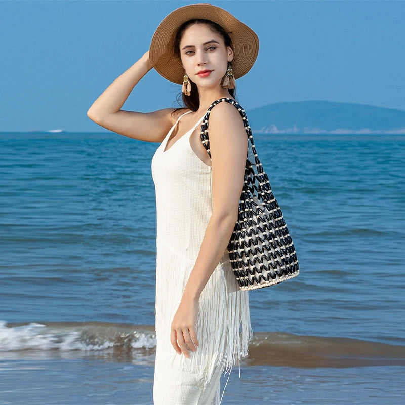 Hollow wood bead straw bag lady fashion brand texture drawstring design shoulder bag simple versatile cylindrical crossbody bag