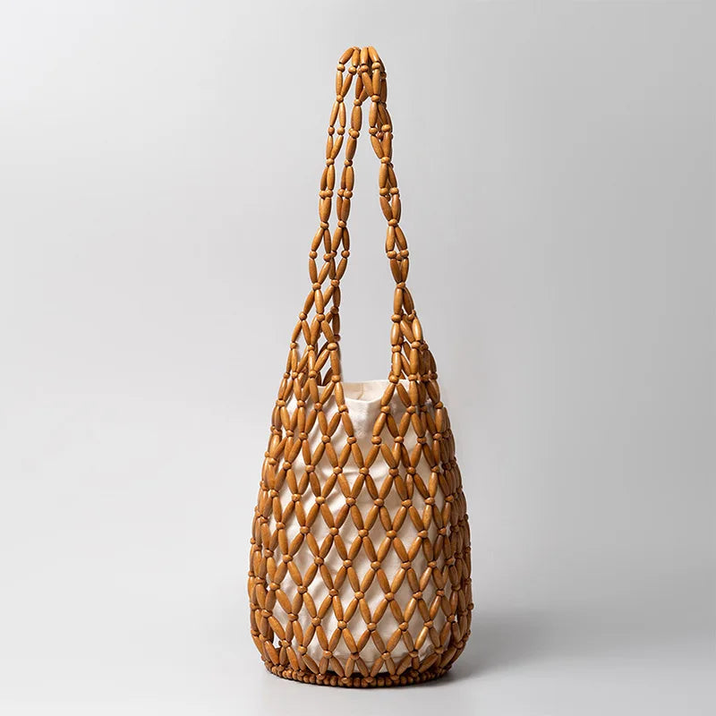Hollow wood bead straw bag lady fashion brand texture drawstring design shoulder bag simple versatile cylindrical crossbody bag