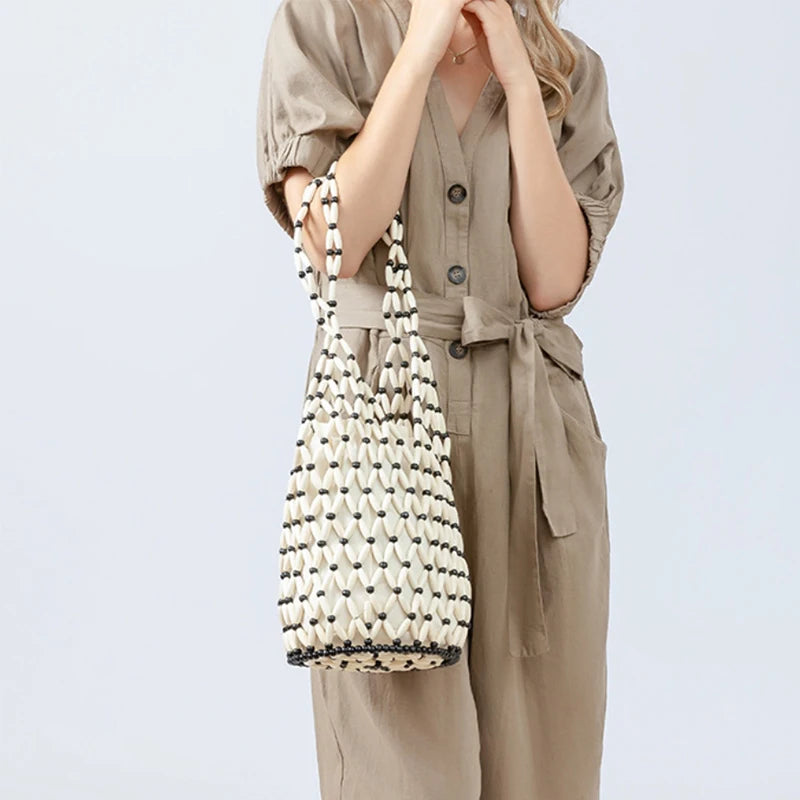 Hollow wood bead straw bag lady fashion brand texture drawstring design shoulder bag simple versatile cylindrical crossbody bag