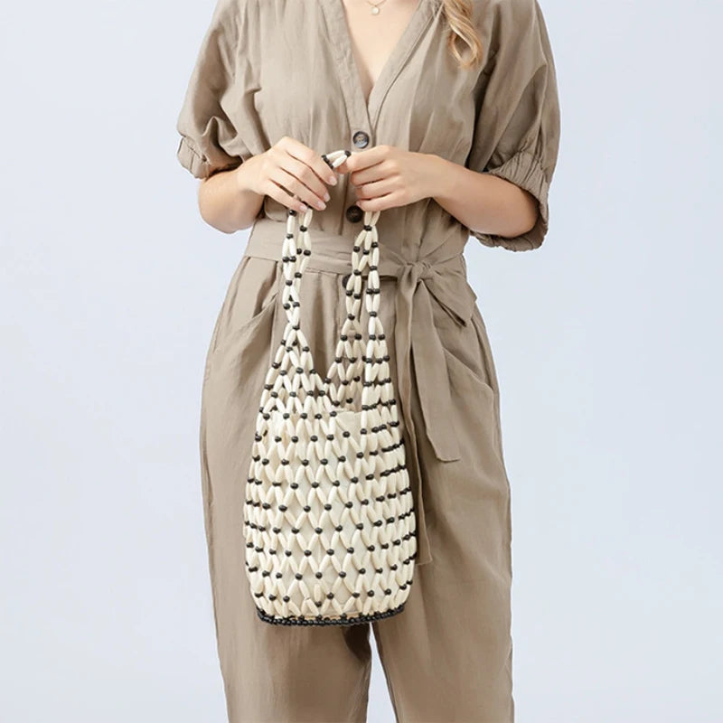 Hollow wood bead straw bag lady fashion brand texture drawstring design shoulder bag simple versatile cylindrical crossbody bag