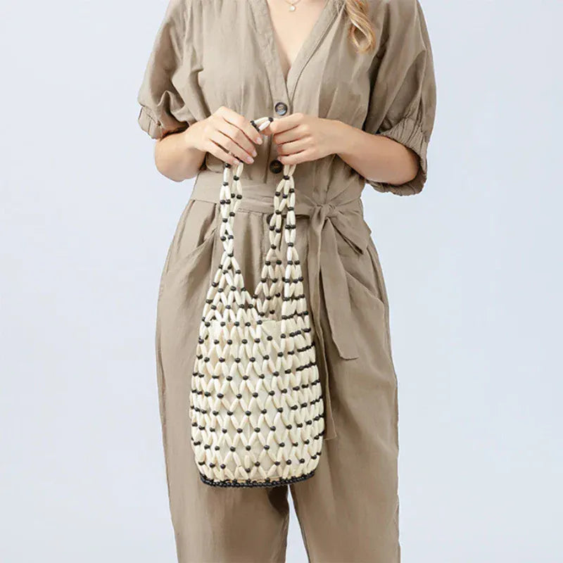 Hollow wood bead straw bag lady fashion brand texture drawstring design shoulder bag simple versatile cylindrical crossbody bag